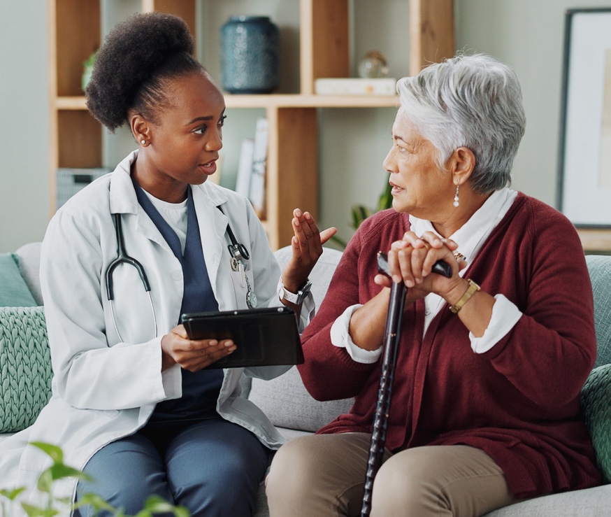 Elderly, woman and doctor with tablet for consultation with expert advice, explaining and healthcare support. Senior patient, nurse and discussion in nursing home, medical diagnosis and assessment